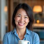 Smiling woman, Sarah, 48, enjoying a calm morning with a cup of tea, looking relaxed and healthy.